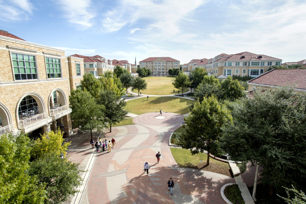 photo of campus buildings and corridor with a few students walking 